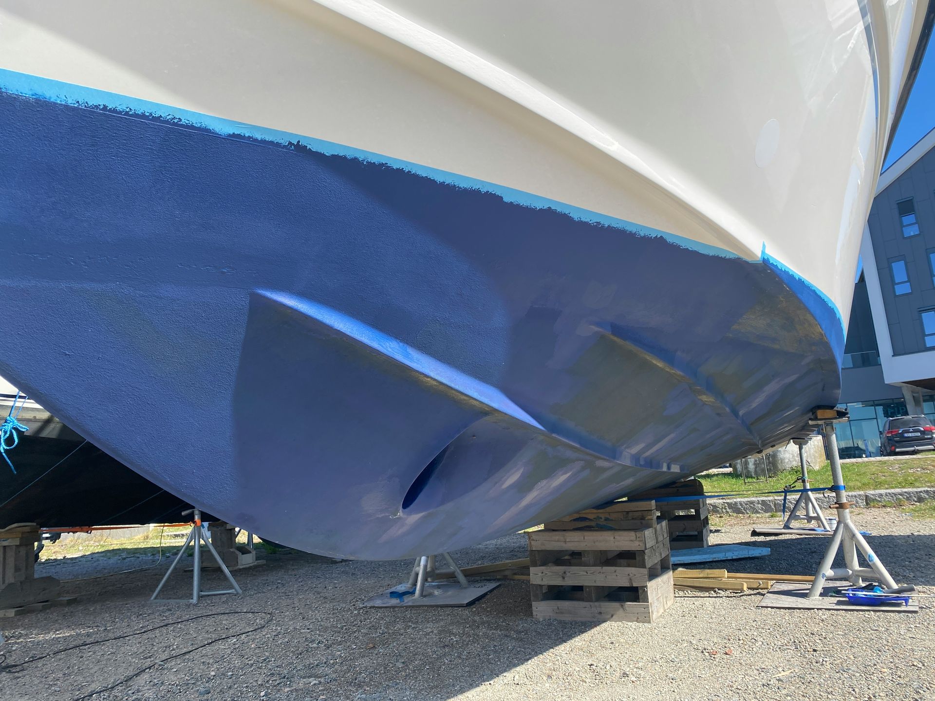 a blue and white boat being worked on